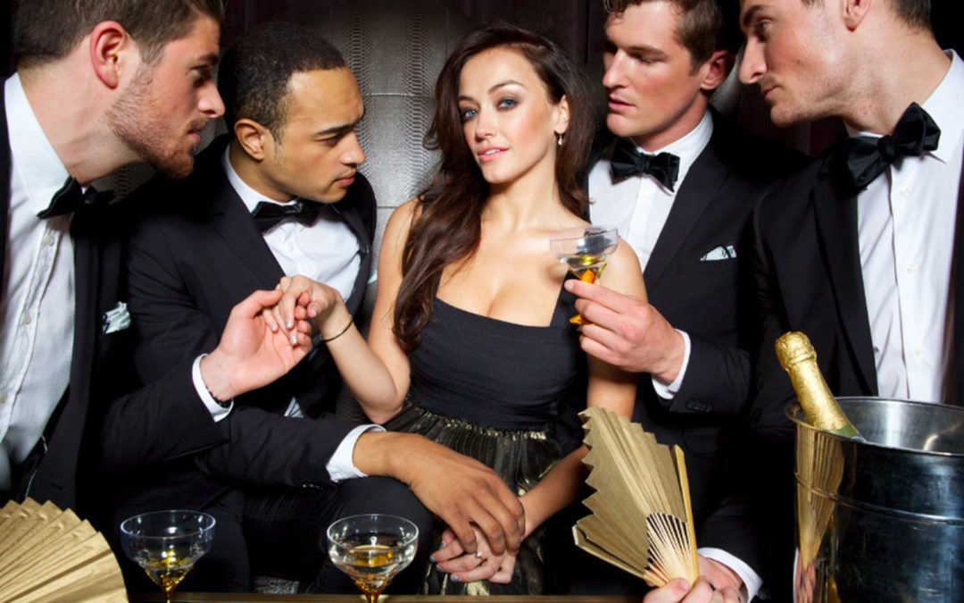 a group of people standing next to a person in a suit and tie