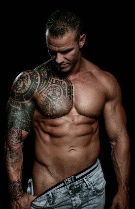 a man with a tattoo on his board