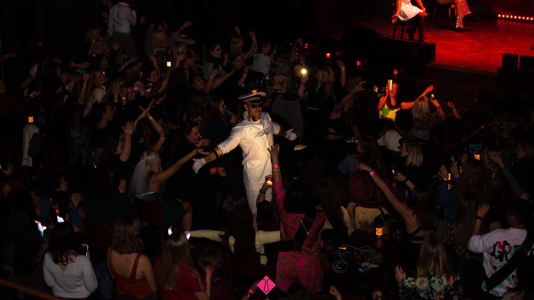 a group of people performing on stage in front of a crowd