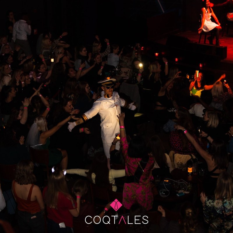 a group of people performing on stage in front of a crowd