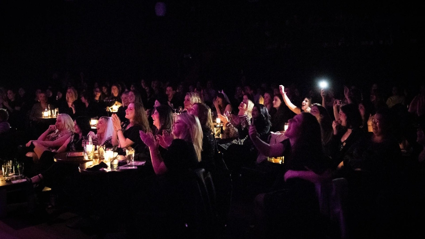a group of people on a stage in front of a crowd