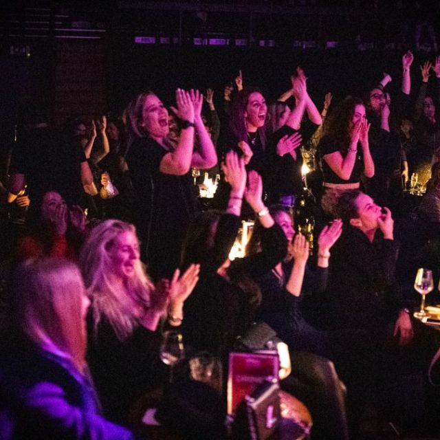 a group of people on a stage in front of a crowd
